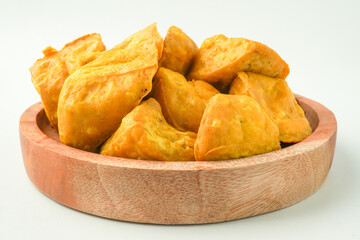 Tahu Takwa is tofu that has a yellow color by soaking tofu in turmeric water. Fried yellow tofu is a specialty food from Kediri, East Java, Indonesia. Concept for Plant based protein.