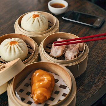 Chinese steamed pork shumai, steamed pork bun, sweet bun and dampling in bamboo steamer