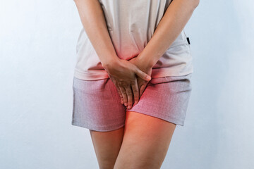 Woman hands holding her crotch suffering from pelvic pain or itchy.