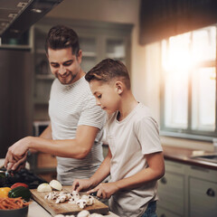 Cooking, dad and son in kitchen, teaching and ingredients with time together, hobby and child development. Parent, father or boy with nutrition, learning and help with support, care or family in home