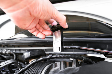 Mass air flow sensor in a hand of air intake manifold in the car engine , Automotive parts concept