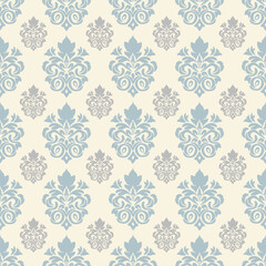 Ornate teal damask pattern on a cream background, featuring symmetrical floral and scroll motifs in a repeating design.