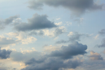 It's a blue sky with atmospheric puffy clouds.