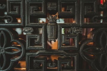 Intricate carved wooden latticework with floral designs, a traditional Chinese architectural...
