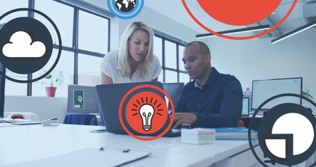 Image of icon in circles over diverse coworkers discussing reports on laptop in office