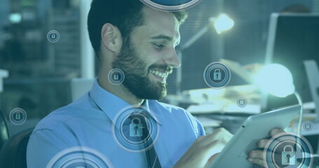 Image of padlock in circles over caucasian man scrolling on smartphone in office