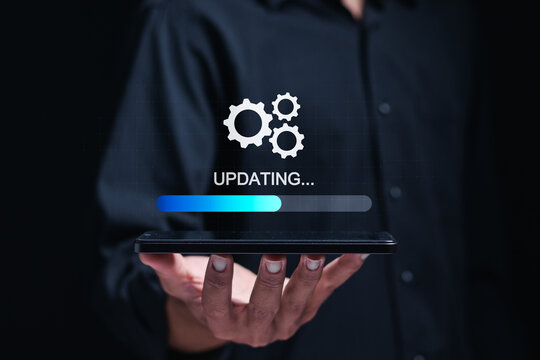 Businessman use smartphone to installing update process. Software updates or operating system upgrades to keep your device up to date with enhanced functionality in new versions and improved security