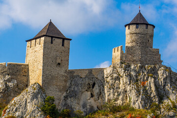 Fototapeta premium Majestic Golubac fortress atop rocky cliffs by Danube river in Serbia on a clear day