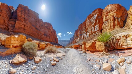A narrow desert canyon with towering red rock walls, the path winding deeper into the arid landscape.