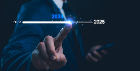 Businessman touch on loading progress from 2023 to 2025,Planning and challenge strategy in new year 2024 Concept. New business startup to 2025. New year 2025 is loading, calendar date, end of the year