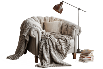 a cozy armchair with a soft blanket draped over its seat and a tall lamp.