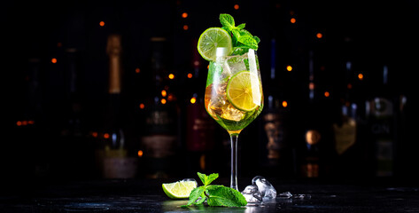 Popular summer cocktail drink with sparkling wine, elderflower syrup, soda, lime, mint and ice in...
