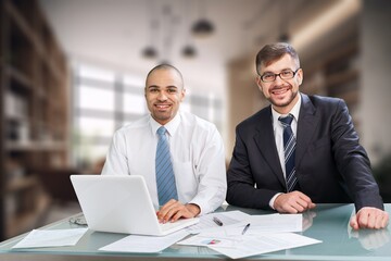 Two busy business colleagues working together