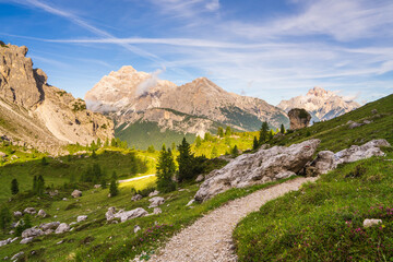 Majestic mountains of the Dolomites. Emerald green grass. tourist trail. Amazing natural landscape background. A popular tourist destination for adventure and trekking