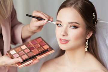 Wedding Eyeshadow Palette. Makeup Artist doing Bridal Make up applying Shadow. Beautiful Bride preparation. Wedding Salon