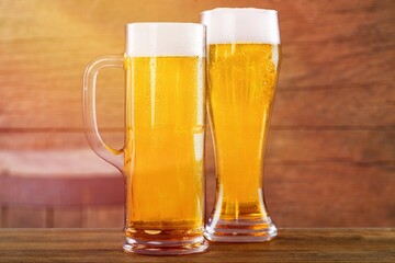 Tasty fresh beer in glass on the desk