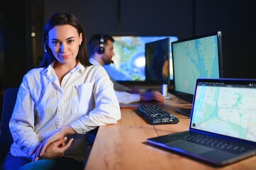 Center of dispatching maintenance. Portrait of cheerful woman and man working via headset...