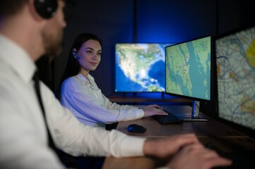 Center of dispatching maintenance. Portrait of cheerful woman and man working via headset...