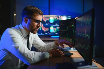 Crypto trader investor analyst looking at computer screen analyzing financial