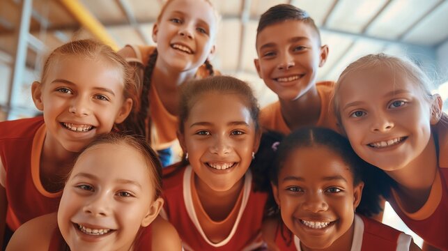A joyful team of young students from diverse backgrounds, posing with smiles and showing their strong bond and team spirit in a modern indoor sports venue.