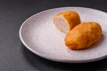 Naklejka premium Delicious chicken Kiev or potato cutlets with salt, spices and herbs
