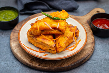 Selective Focus of Bread pakora is a popular Indian street food made with bread, stuffed with spicy...