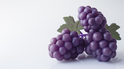 Fototapeta premium Rubber toy grapes for children on a white background enhancing child development through play Text space available