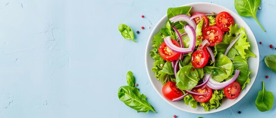  A white bowl holds lettuce, tomatoes, an onion, and a red onion atop a blue surface