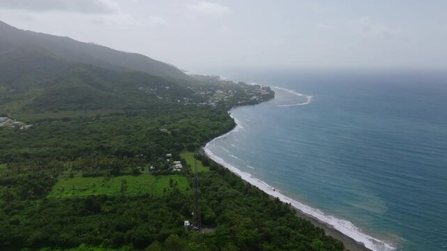 Wide aerial footage in the morning of the southern coastline of Puerto Rico showing the town of Patillas.