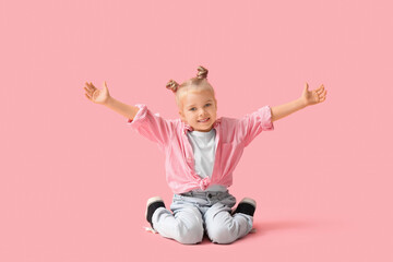 Cute little girl opening arms for hug on pink background