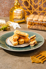 Kue lidah kucing with chocolate jam is a small Indonesian biscuit (kue kering) shaped somewhat like a cat's tongue (long and flat). They are sweet and crunchy.