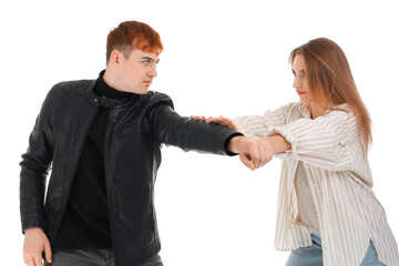 Young woman defending herself on white background