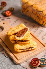 Kue lidah kucing with chocolate jam is a small Indonesian biscuit (kue kering) shaped somewhat like a cat's tongue (long and flat). They are sweet and crunchy.