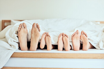 Family, feet and blanket in bedroom at house for sleeping, bonding and tired with security on...