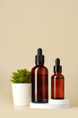 Set of brown glass bottles with essential oils on stand on beige background
