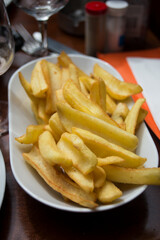 closeup of french fries in a white plate at the restaurant