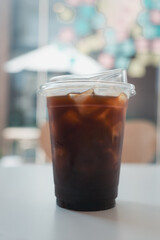 Closeup of take away plastic cup of iced black coffee