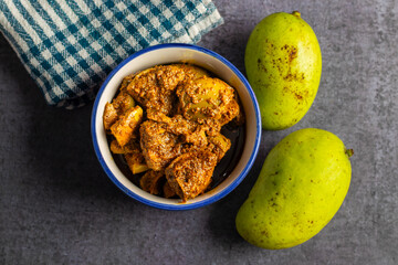 Indian mango pickle is a piquant condiment, bursting with tangy, spicy flavors. Made with raw mango, spices like mustard oil, turmeric, and chili, it's a traditional, homemade delicacy enjoyed across.