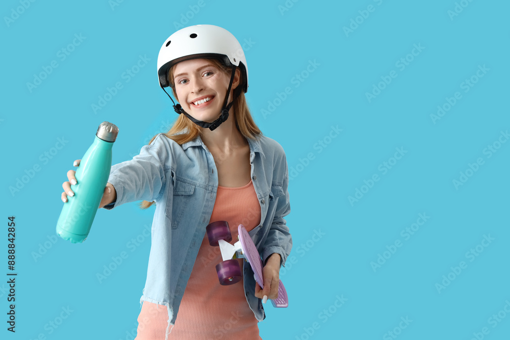 Sticker Beautiful young woman in helmet with skateboard and sports bottle on blue background