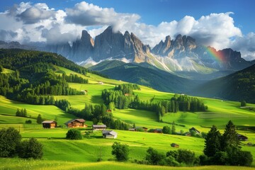 Obraz premium Picturesque mountain landscape with vibrant green meadows traditional houses and a vivid rainbow