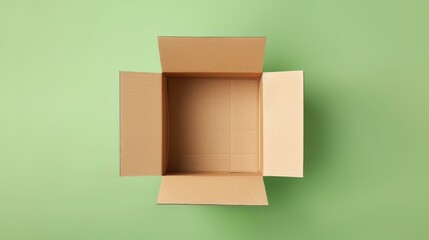 Minimalistic top view of an empty brown cardboard box on a light green background.