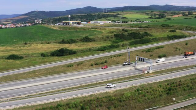 Drone shot of European route E50 highway through green agricultural fields landscape, Levoca