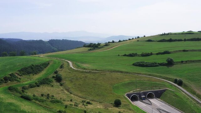 Aerial view of European route E50 highway through green agricultural fields landscape, Levoca