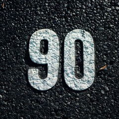 Weathered 90 Road Marking on Asphalt. Anniversary, birthday, symbol concept image.