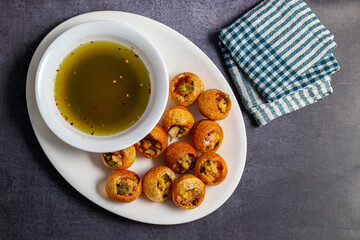 Exploring the Tangy, Spicy, and Refreshing Delight of Pani Puri. India's Favourite Street Food Experience. Selective focus. 
