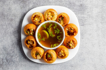 Exploring the Tangy, Spicy, and Refreshing Delight of Pani Puri. India's Favourite Street Food Experience. Selective focus. 