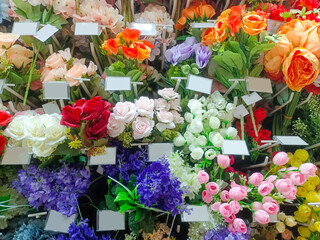 Various Types Of Colorful Plastic Flowers For Room Decoration On Display In A Souvenir Shop