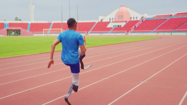 Asian para-athlete with prosthetic blades warms up body in the stadium. 