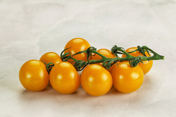 Yellow sweet tomato on the branch