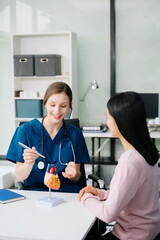 Obraz premium Portrait of female doctor explaining diagnosis to her patient. Doctor Meeting With Patient In Exam Room.